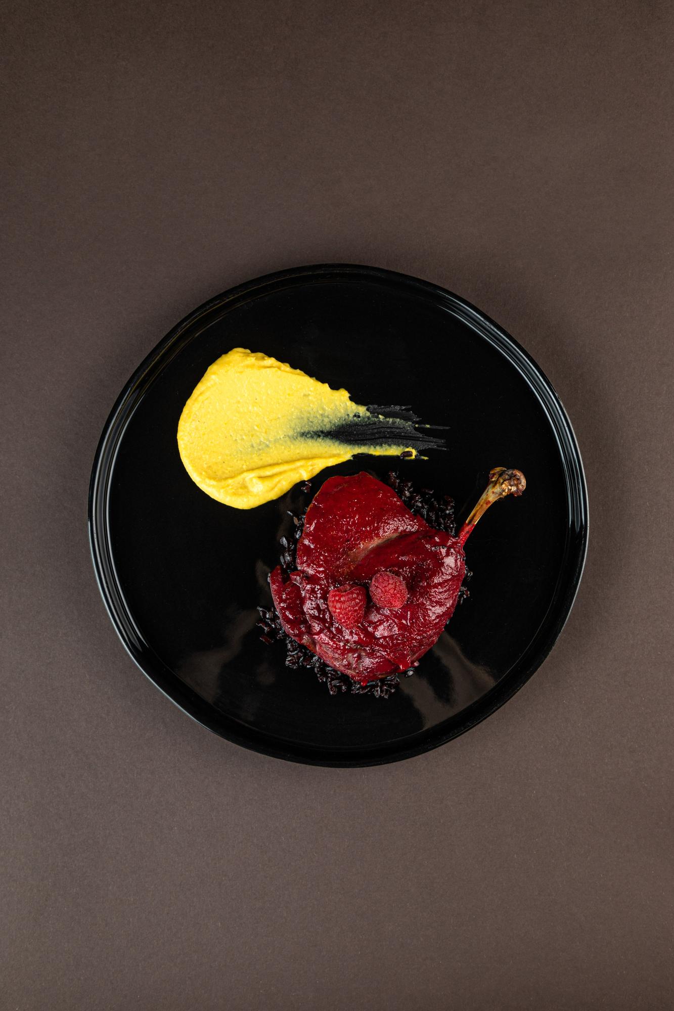 plated experimental appetizer on dark plate