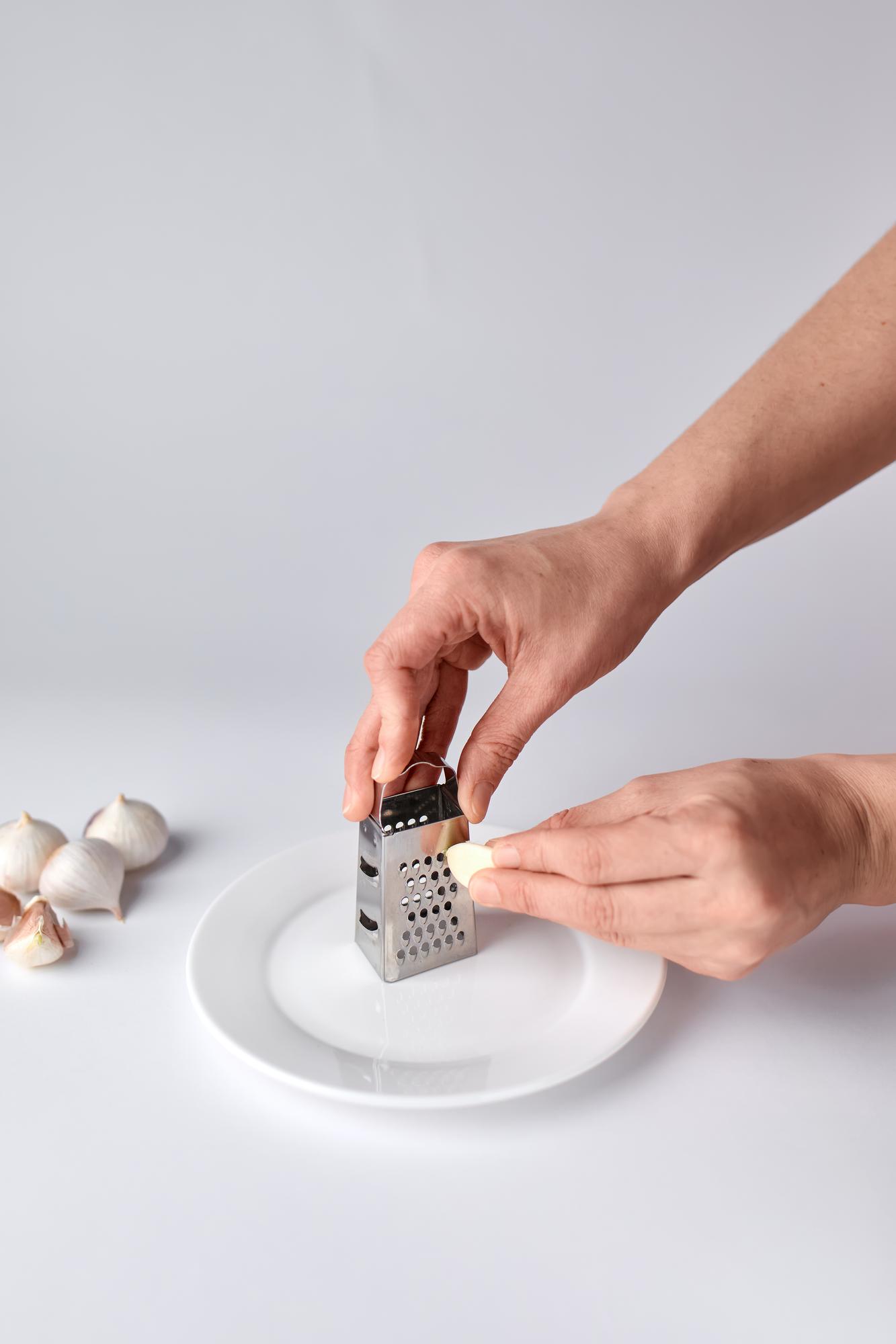 hands seasoning dish with modern tools