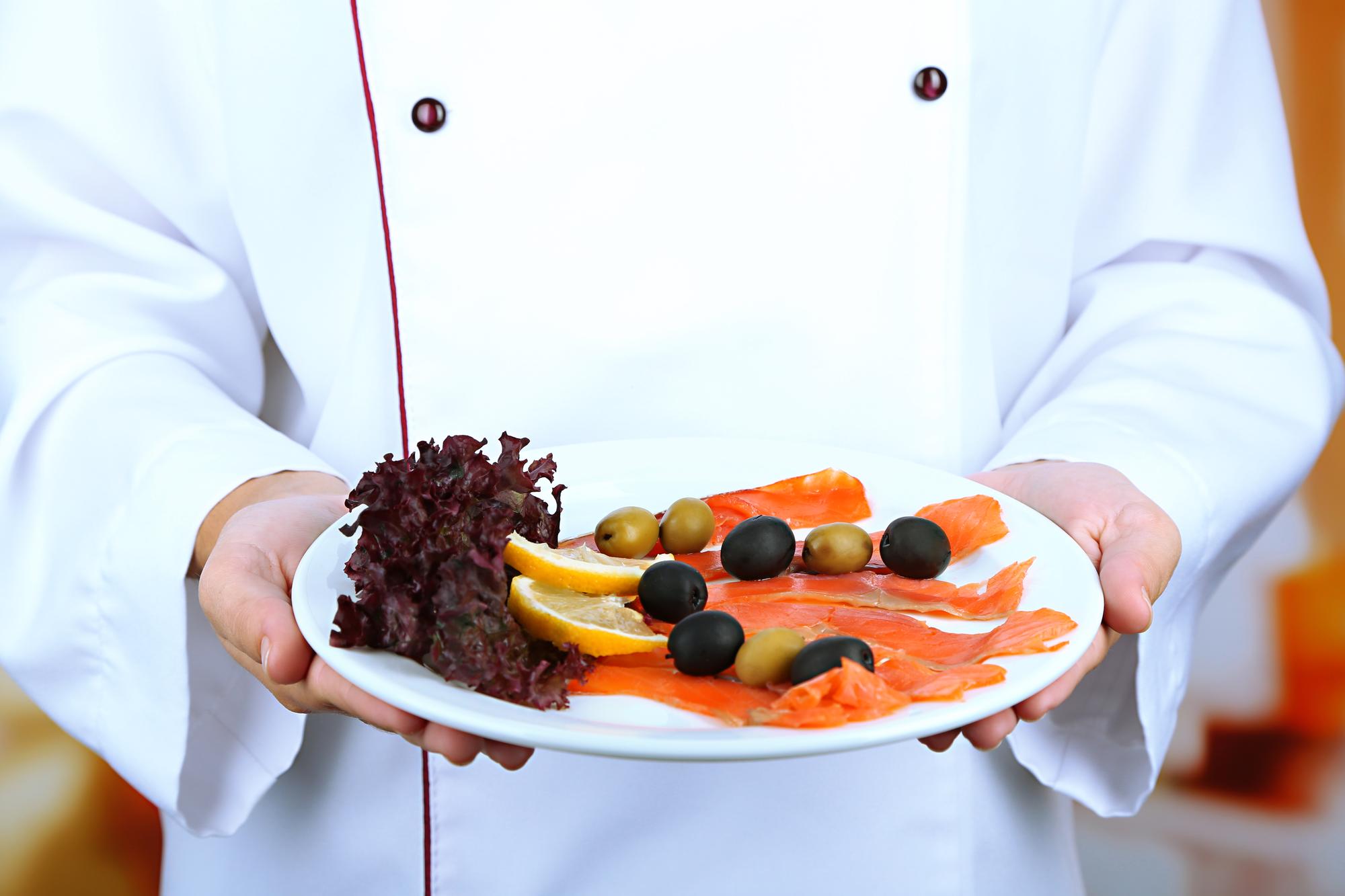 chef preparing modern plated dish with tech tools